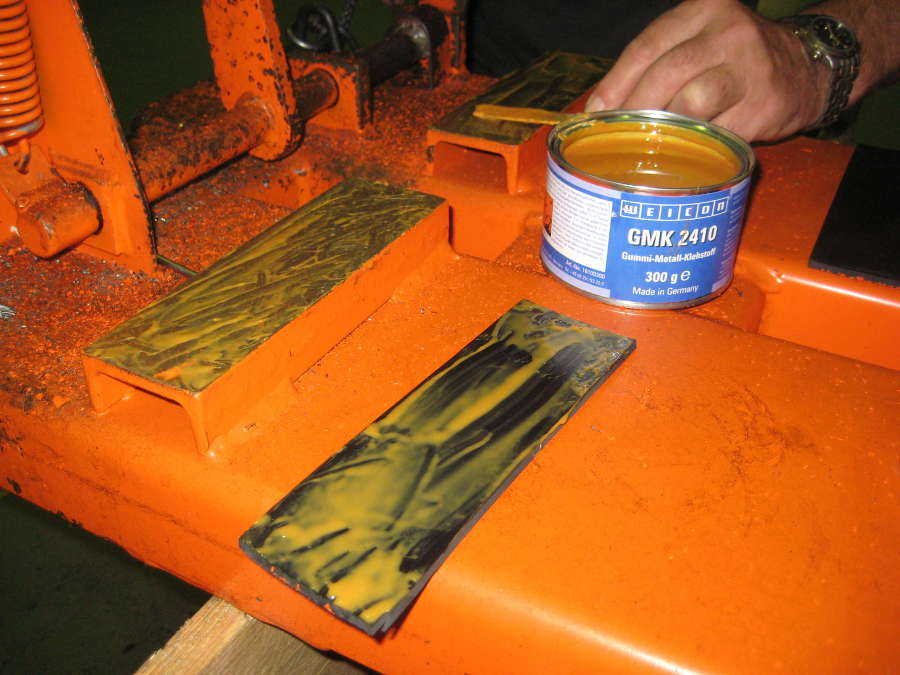 Attaching a rubber wear strip to painted metal construction machinery with GMK 2410 Rubber Metal Contact Adhesive
